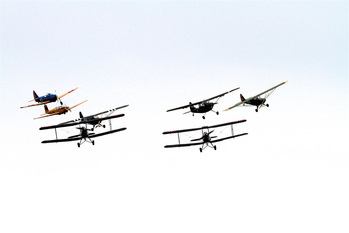 Vintage biplanes flying in formation