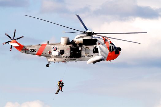 Person Showing White and Orange Helicopter