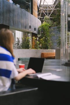 Student studying in a campus atrium, photo by Anna Shvets on Pexels