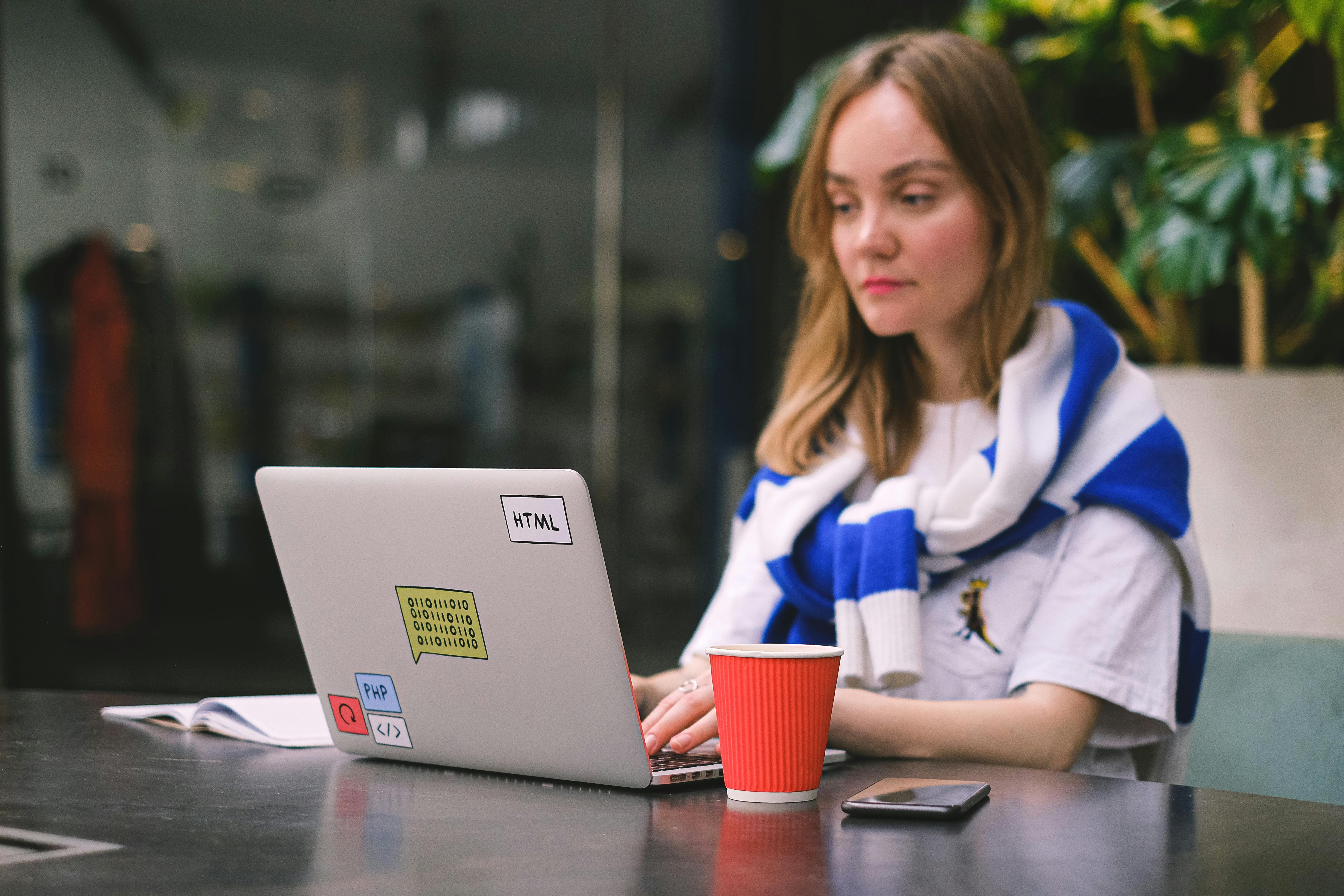 a woman busy working on her laptop