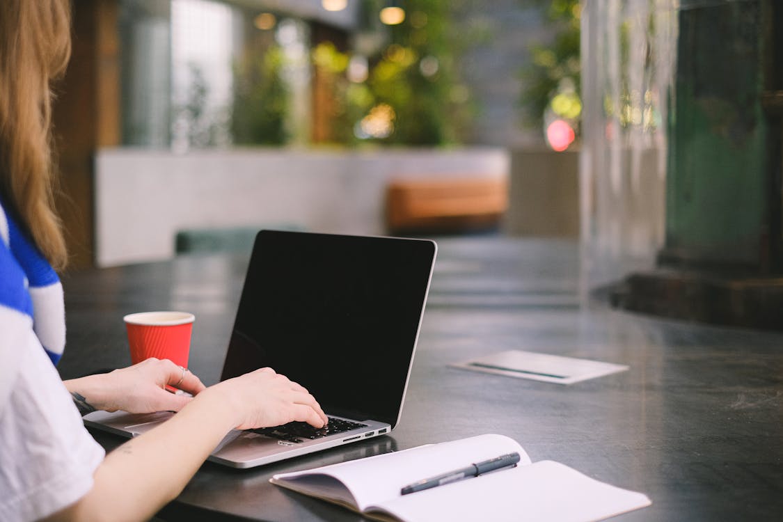 Free Person Using Black Laptop Computer Stock Photo