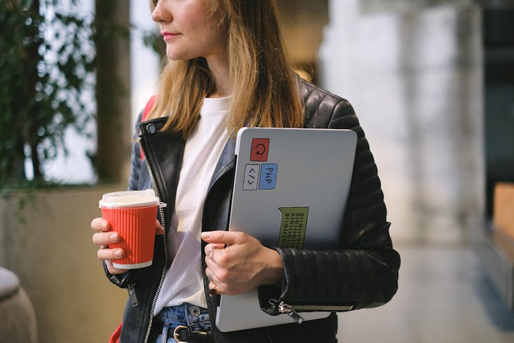 A Woman Holding A Laptop