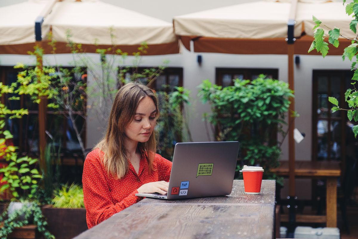 Builder working on a laptop in a plant-filled workspace, photo by Anna Shvets on Pexels