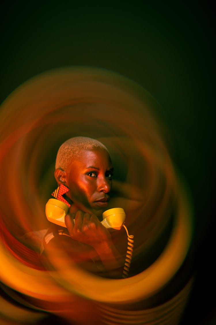 Man Holding A Vintage Yellow Phone 