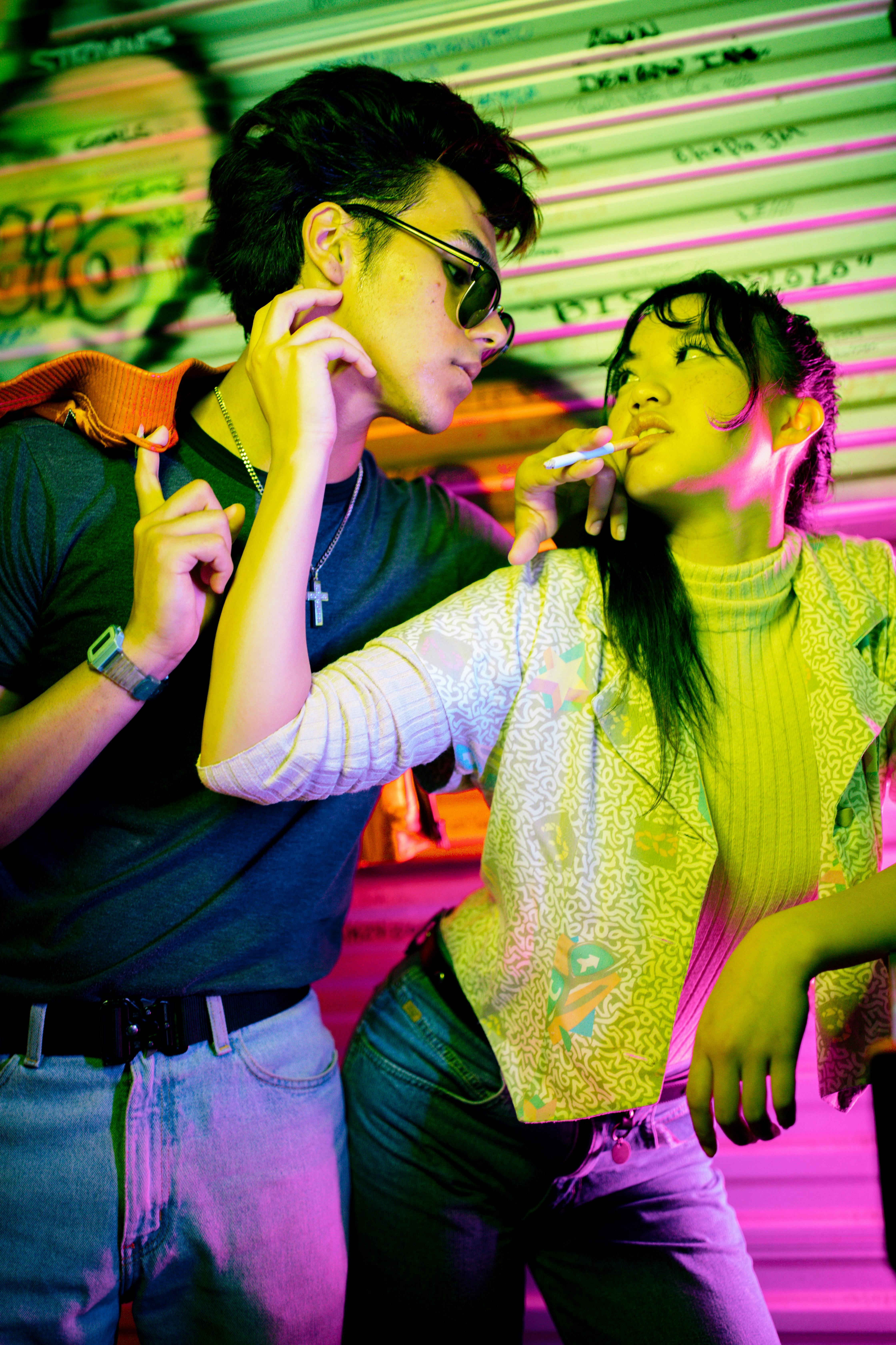 man and woman posing on a vintage photoshoot and smoking a cigarette