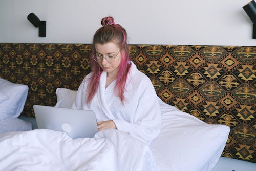 Woman in a Robe Using Her Laptop