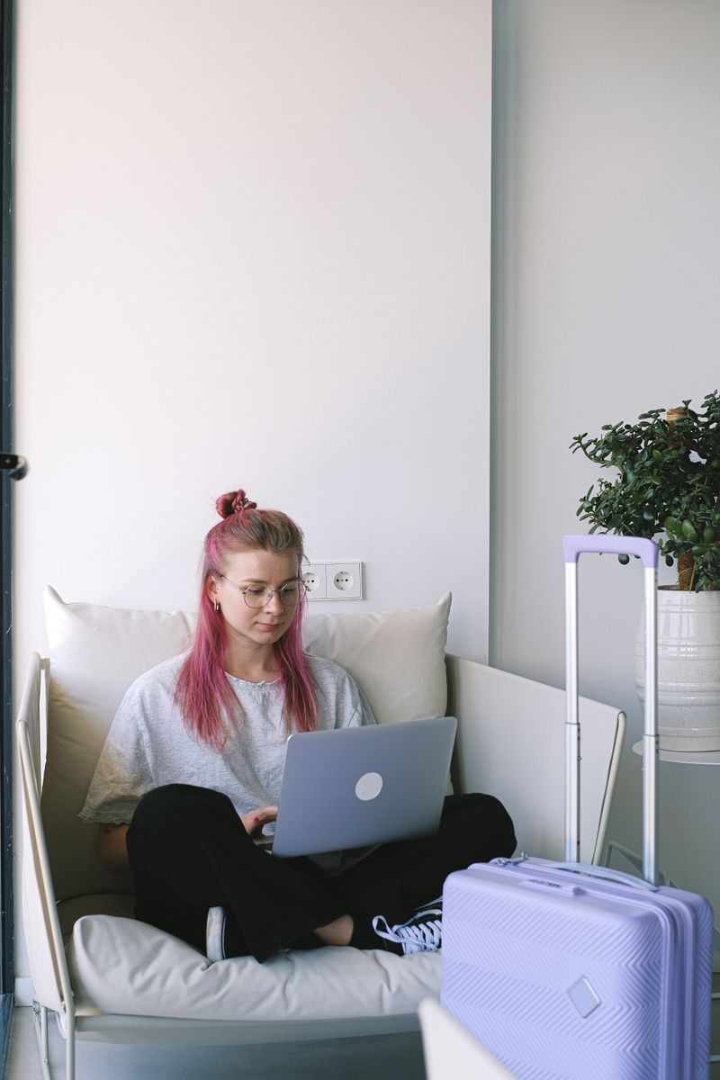 Digital nomad woman working in hotel room