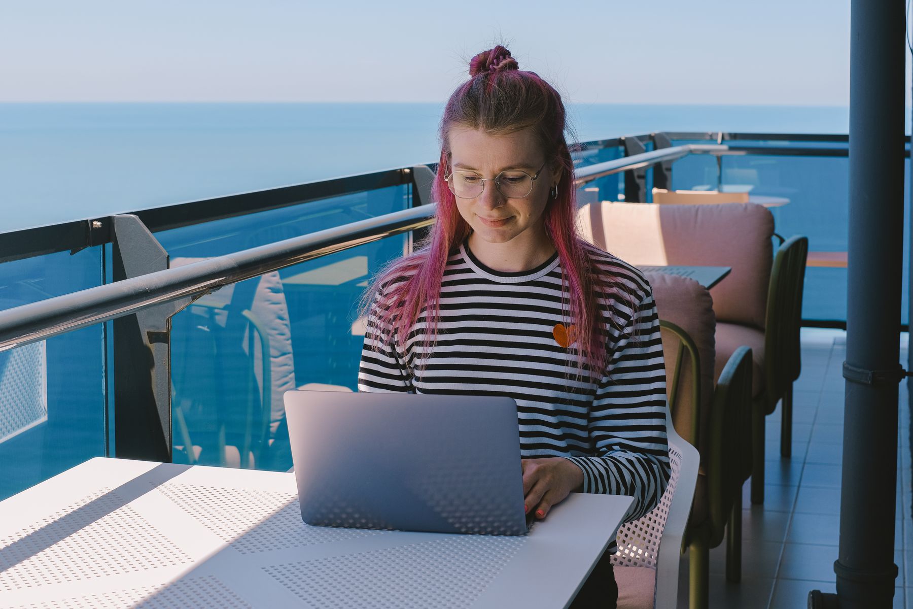 Remote worker using a laptop with ocean view