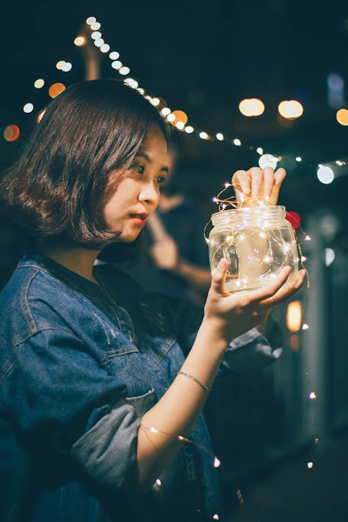 Free Photo of Woman Holding Jar With String Lights Stock Photo