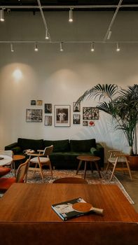 A stylish room in Istanbul with retro decor, green sofa, and framed art.