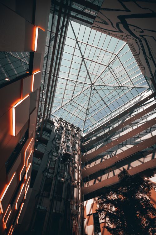 Free Dynamic view of a modern atrium featuring a glass ceiling and architectural elements in Geneva, Switzerland. Stock Photo