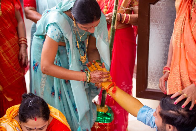 Woman Washing Mans Hand With Yellow Paste