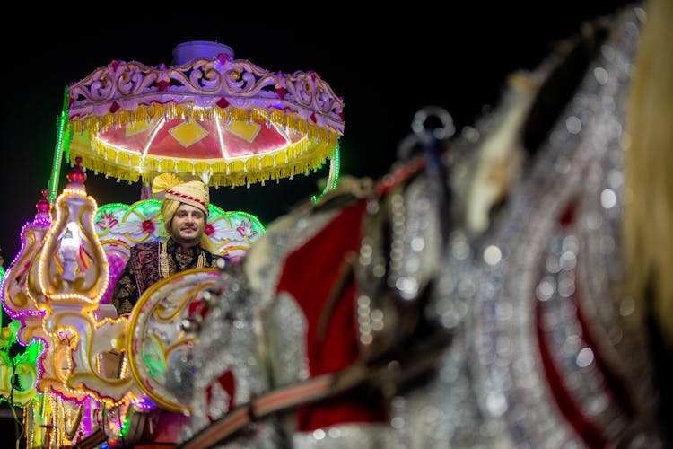 Man Sitting On Decorated Cart