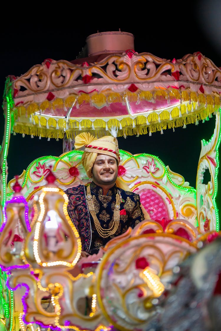 Man Sitting On Decorated Cart