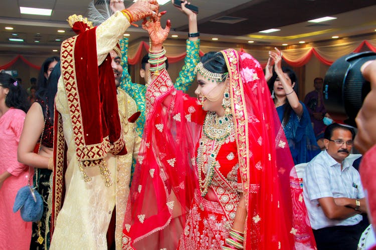 Couple In Traditional Clothes Dancing At Wedding