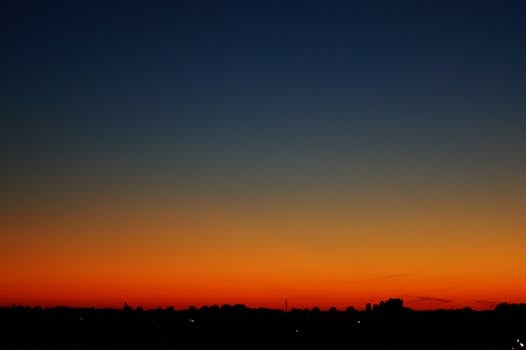 Capture the breathtaking twilight with a vivid gradient sky and silhouetted horizon.