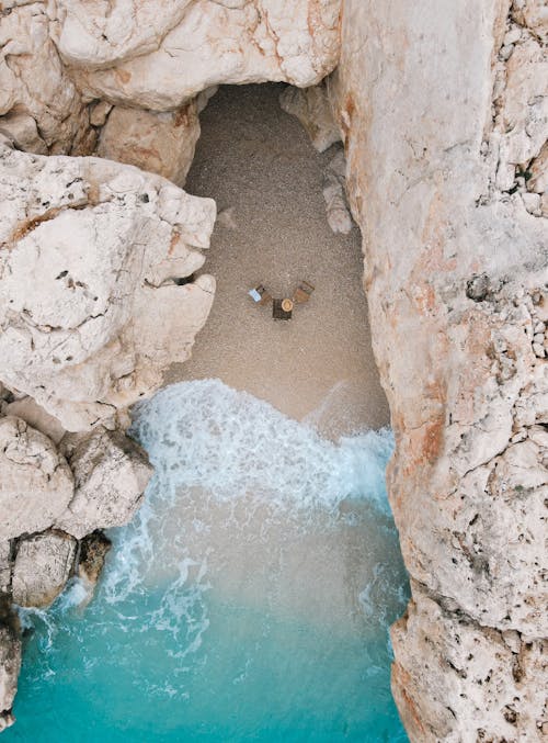 An Aerial Photography of a Beach Between Rock Formations