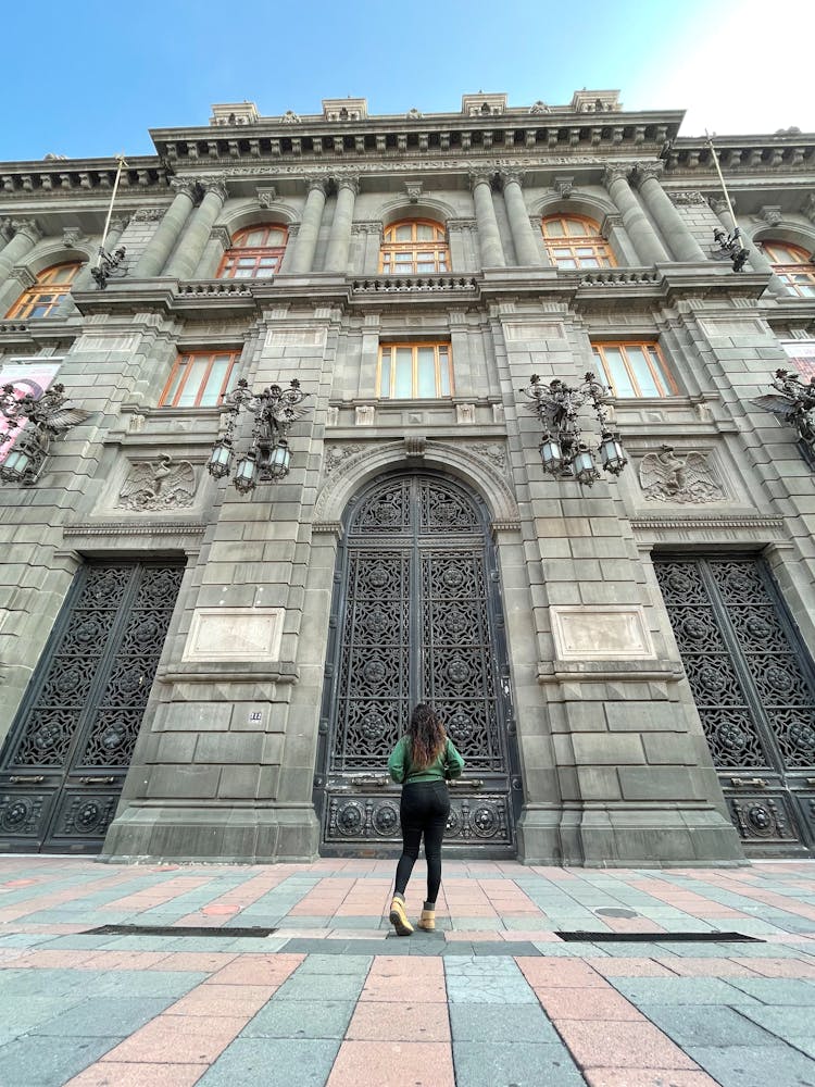 Woman Standing In Front Of An Old Building