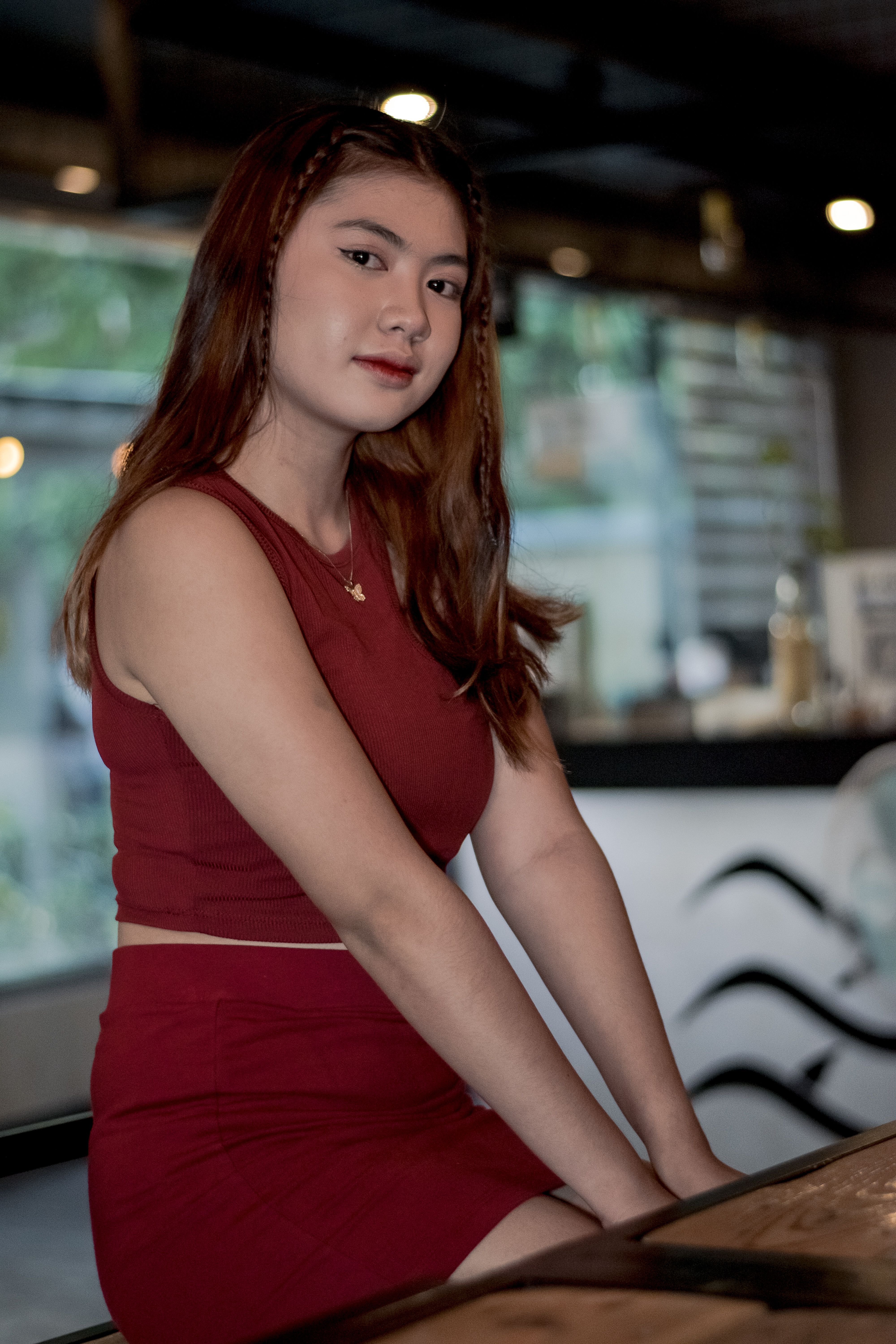 A Beautiful Woman in Brown Tank Top Sitting · Free Stock Photo