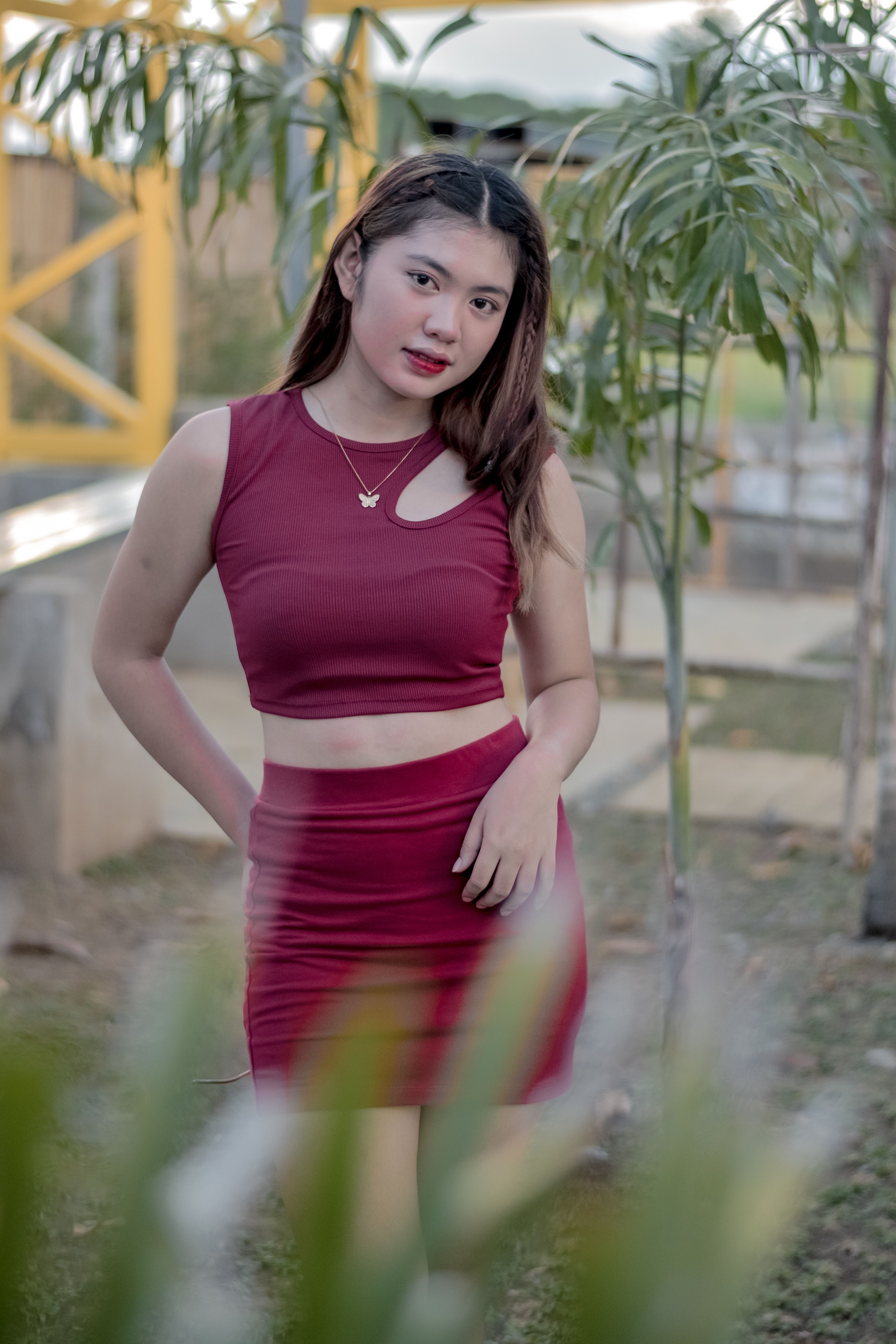 Woman Posing for Photo Next to Small Palm Tree · Free Stock Photo