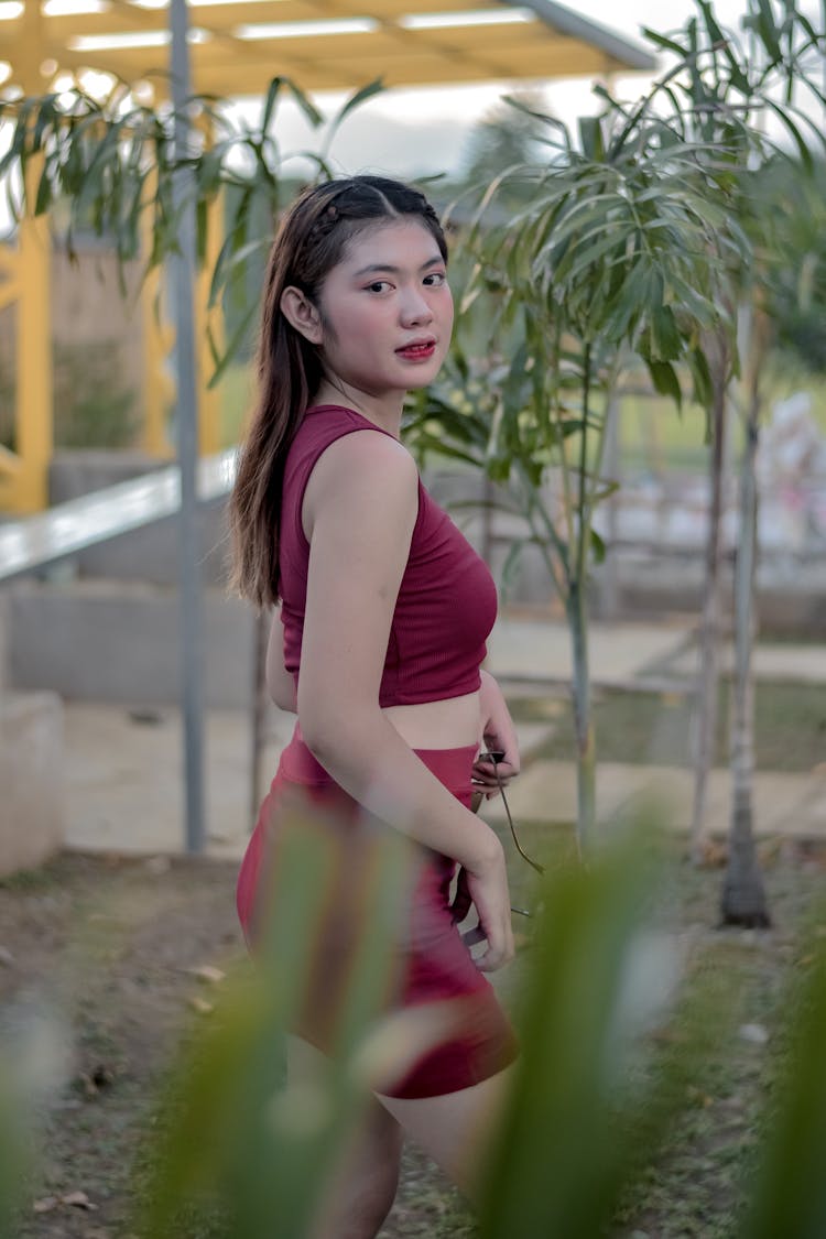 Woman Posing For Photo In Palm Tree Nursery