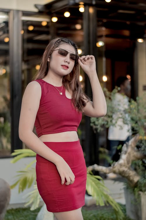 Young Woman Posing Wearing Sunglasses in Red Crop Tank Top and Mini Skirt