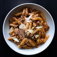 Bowl of penne with shaved cheese, photo by Kirill Zubrilin on Pexels
