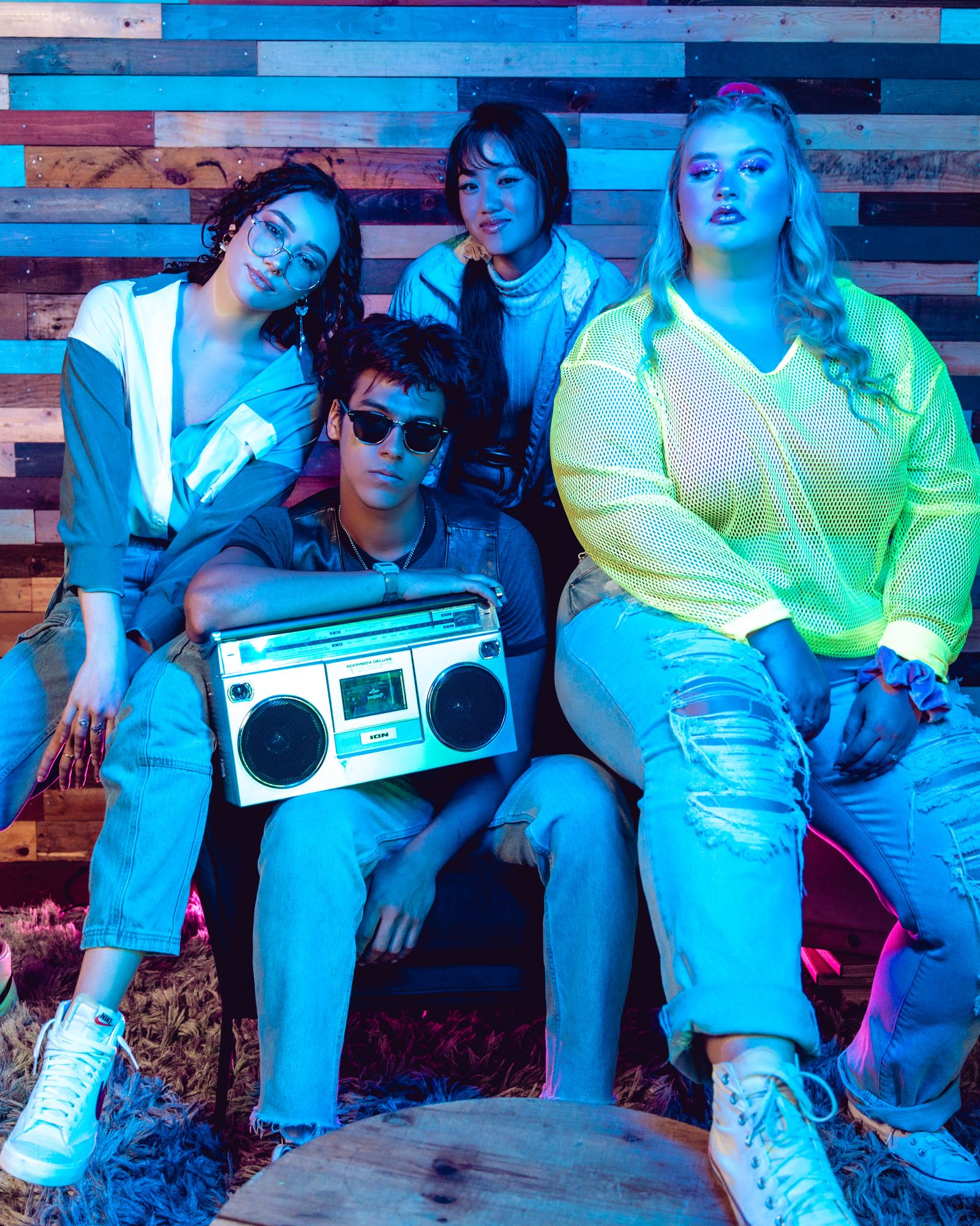 Friends in retro throwback outfits celebrating together at a decade theme party