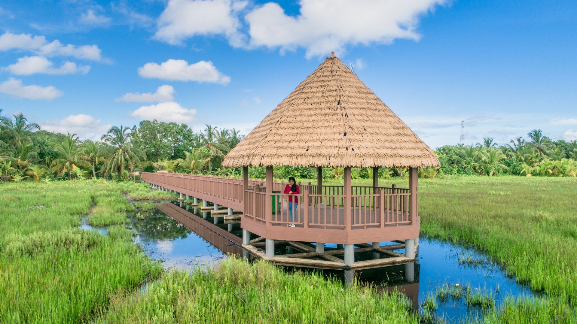 Idyllic wooden gazebo over water in lush Fuvahmulah countryside, Maldives.