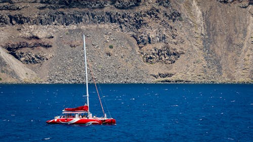 Free Photography of Red Sailing Boat on Sea Stock Photo
