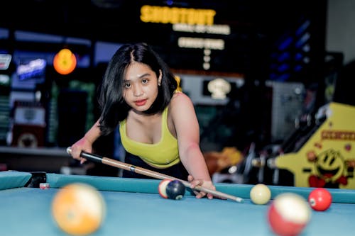 Photo of Teenage Girl Playing Billiards