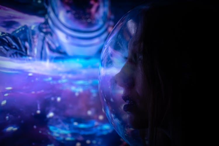 Woman In A Space Helmet Illuminated In Blue