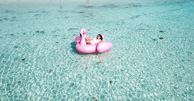 A woman enjoying leisure time on a flamingo float in the clear waters of Isla Mujeres.