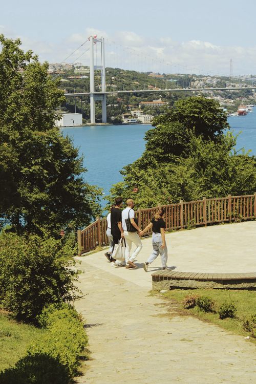 Free People strolling amidst scenic beauty near Bosphorus Bridge, Istanbul. Stock Photo