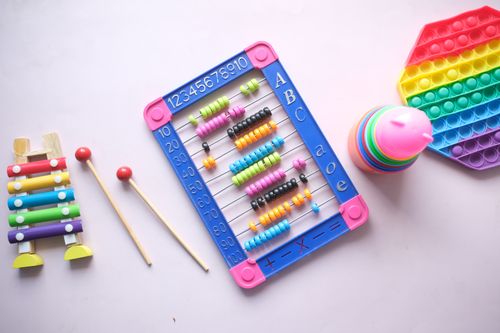 Free A vibrant display of educational toys including an abacus, xylophone, and stacking cups for children. Stock Photo
