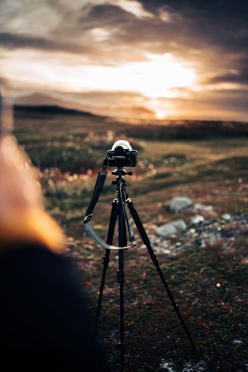 Free Camera on tripod capturing a stunning sunset in Troms og Finnmark, Norway. Stock Photo