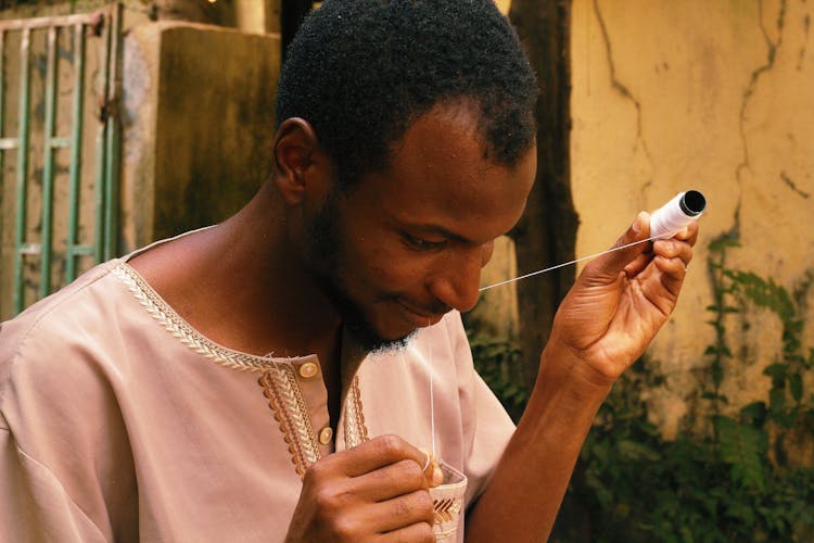 Man Holding Thread