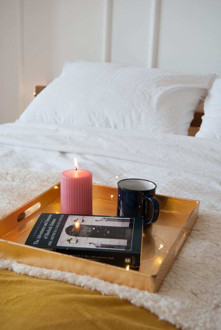 Lighted Candle And Mug On A Wooden Tray