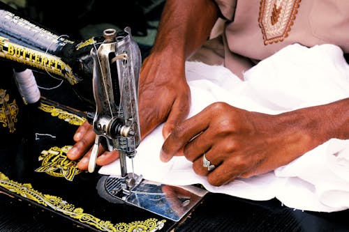 Tailor Sewing a White Textile