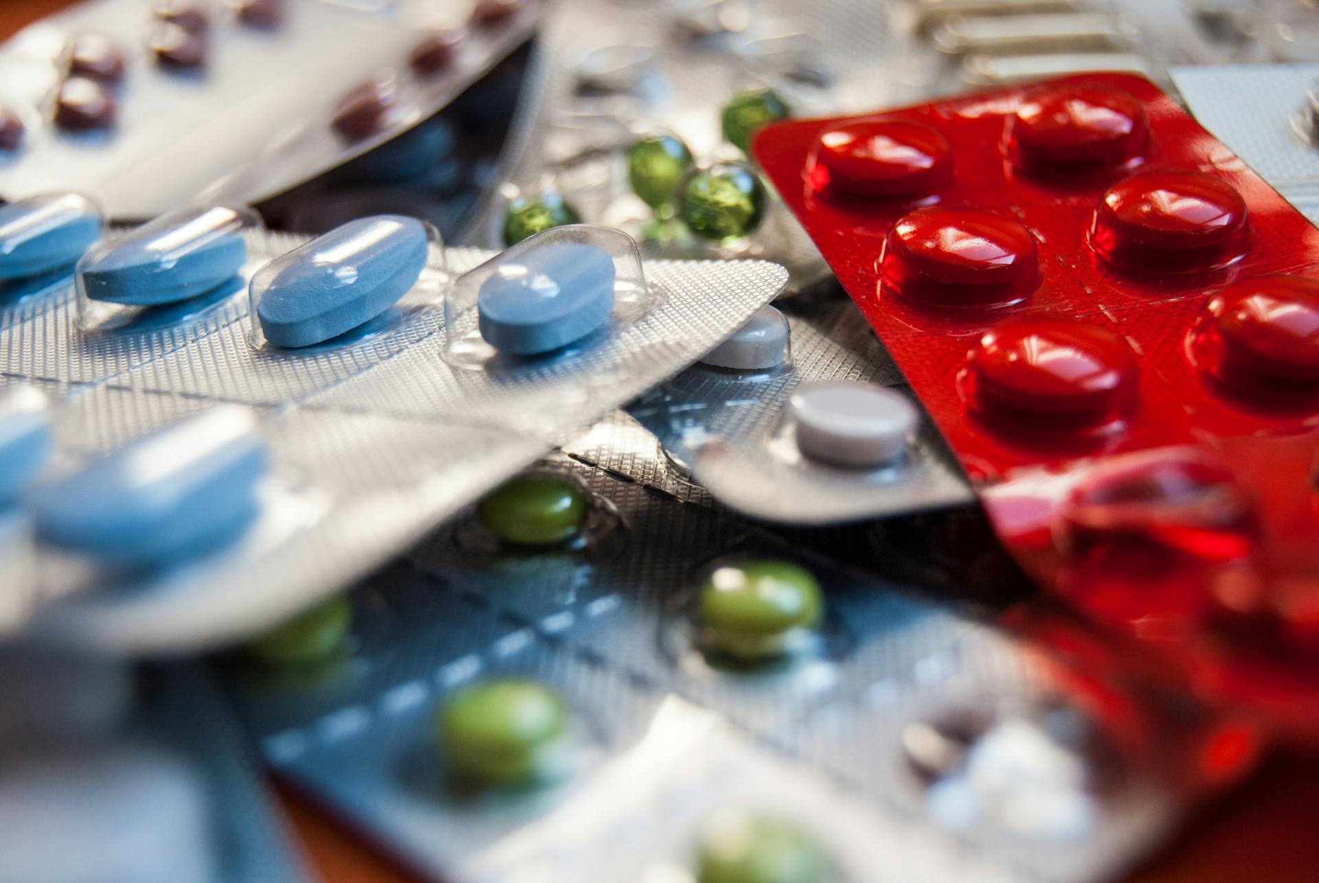 Close-up of various colored medication pills in blister packs.