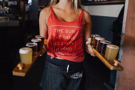 A bartender carries beer flights on wooden trays in a lively pub setting, promoting social atmosphere.
