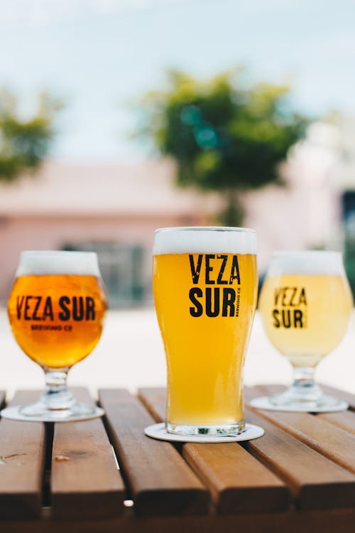 Selective Focus Photography of Beer on Wooden Table