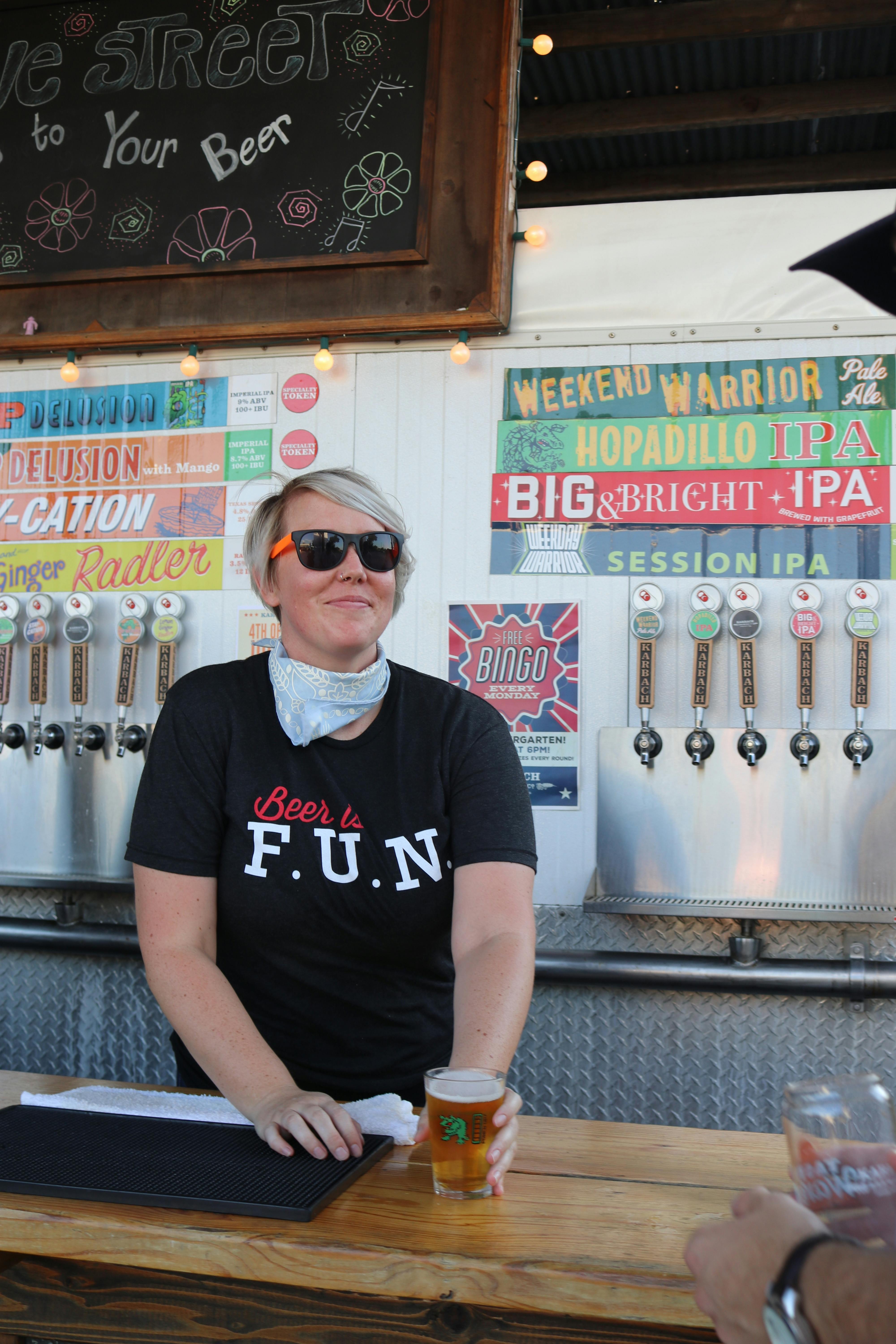 man wearing black sunglasses holding clear beer mug inside bar counter