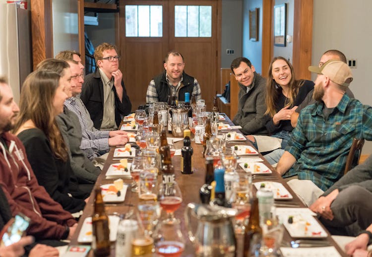 Group Of People Sitting On Dining Table