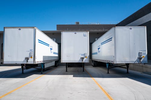 Three White Enclosed Trailers