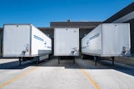Three White Enclosed Trailers