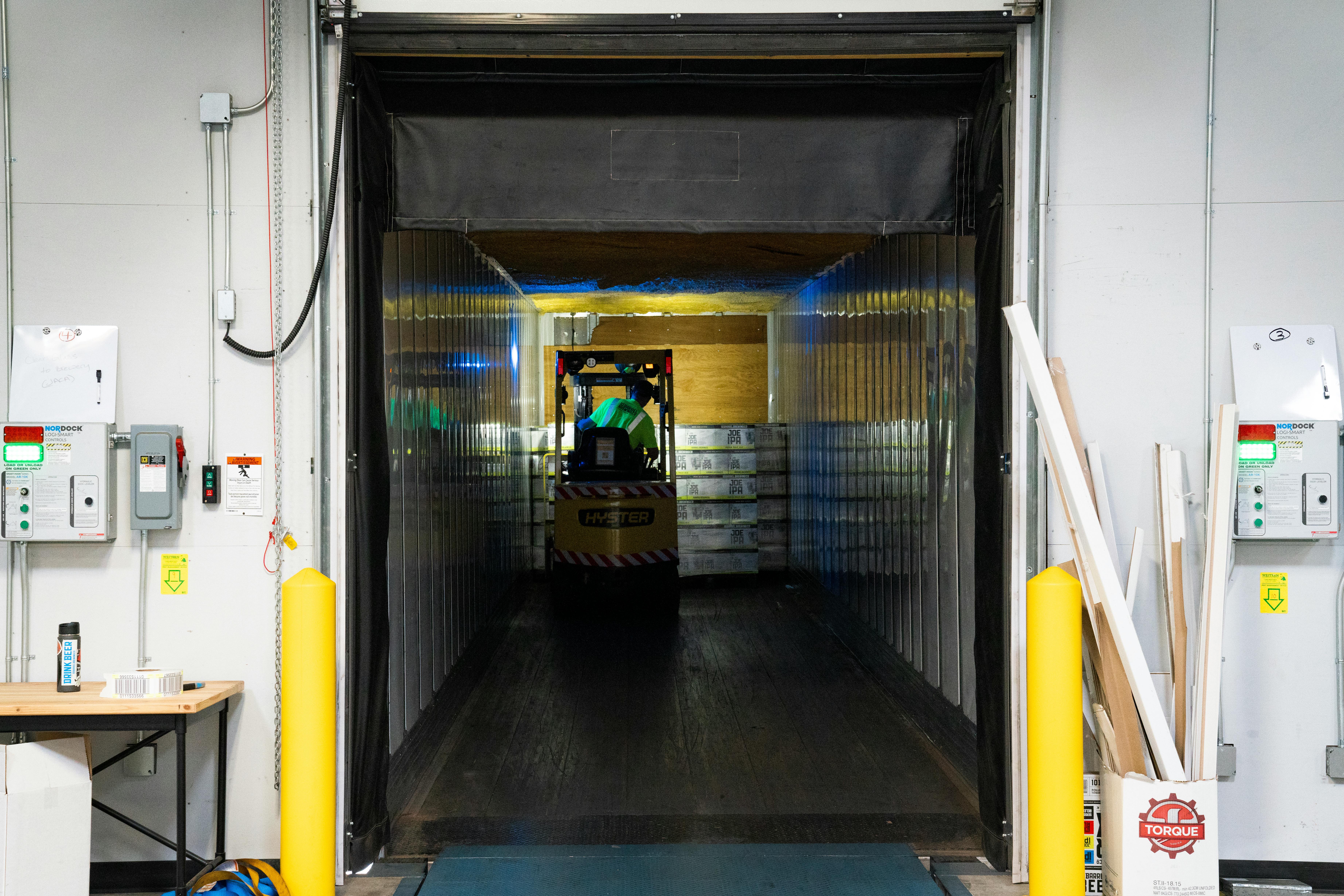 Forklift unloading inventory at a warehouse dock