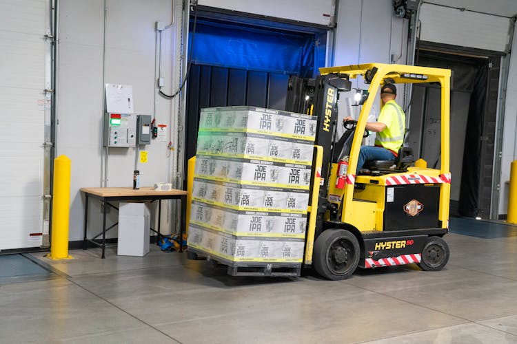 Man Riding On Yellow Forklift