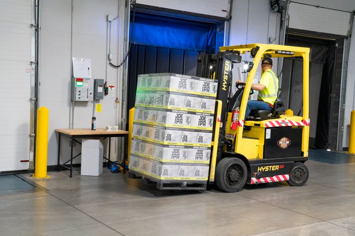 Warehouse worker riding a forklift