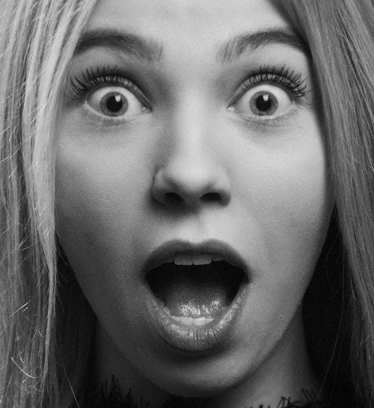 Grayscale Photo Of A Surprised Woman 